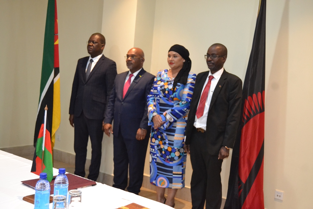 Ministers Mia and Mesquita (middle) pose for a photo flanked by officials from their respective ministries--Photo by Watipaso Mzungu