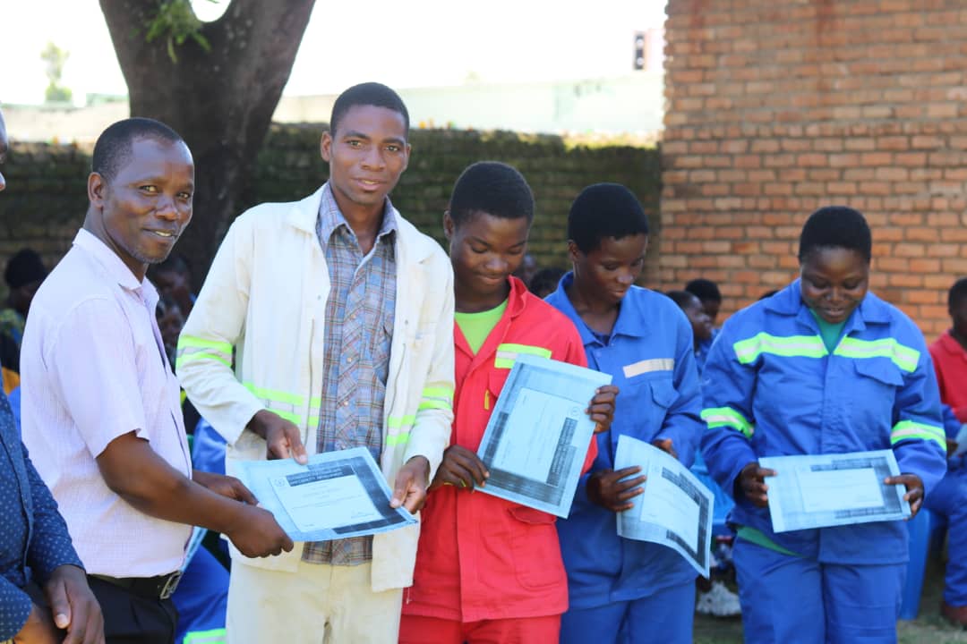 district youth officer Aberson Mwale on the left with some of the candidates that were awarded certificates