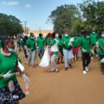 Climate YES members and student teachers picking plastic papers around Area 25 Community Hospital in Lilongwe