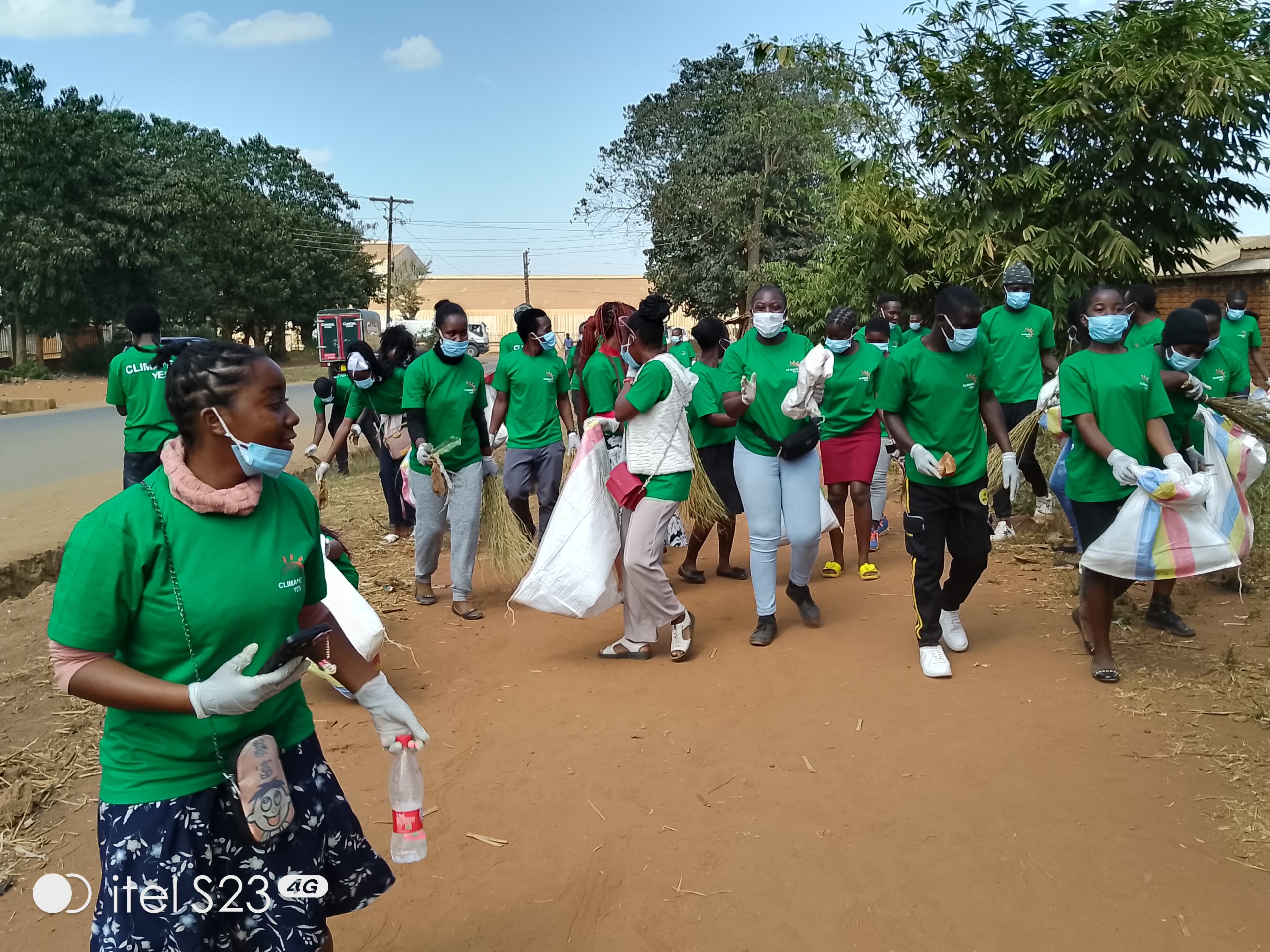 Climate YES members and student teachers picking plastic papers around Area 25 Community Hospital in Lilongwe