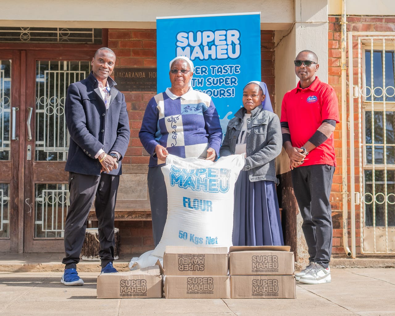 M'bweza and CPL Human Resourcers Manager, Titus Mtonyo, handing over the donation to Sister Linda Viano and her fellow nun