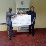 Mr. Jokes (right) receiving a dummy cheque from Mr. Miller John Joshua of Reunion Insurance Company of Malawi