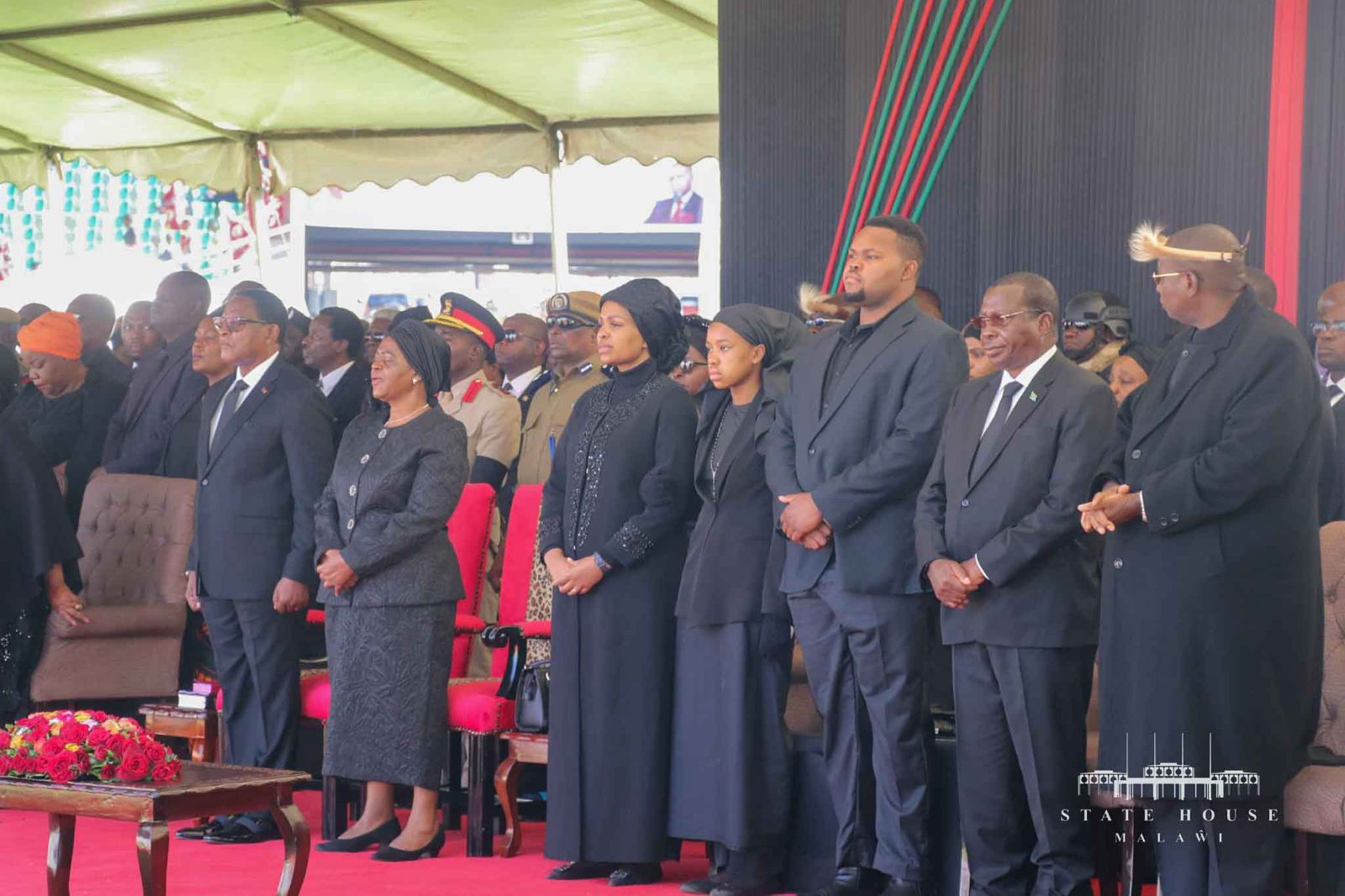 President Chakwera (far left), widow Mary Chilima, Chilima's children and others at the funeral ceremony at Bingu National Stadium