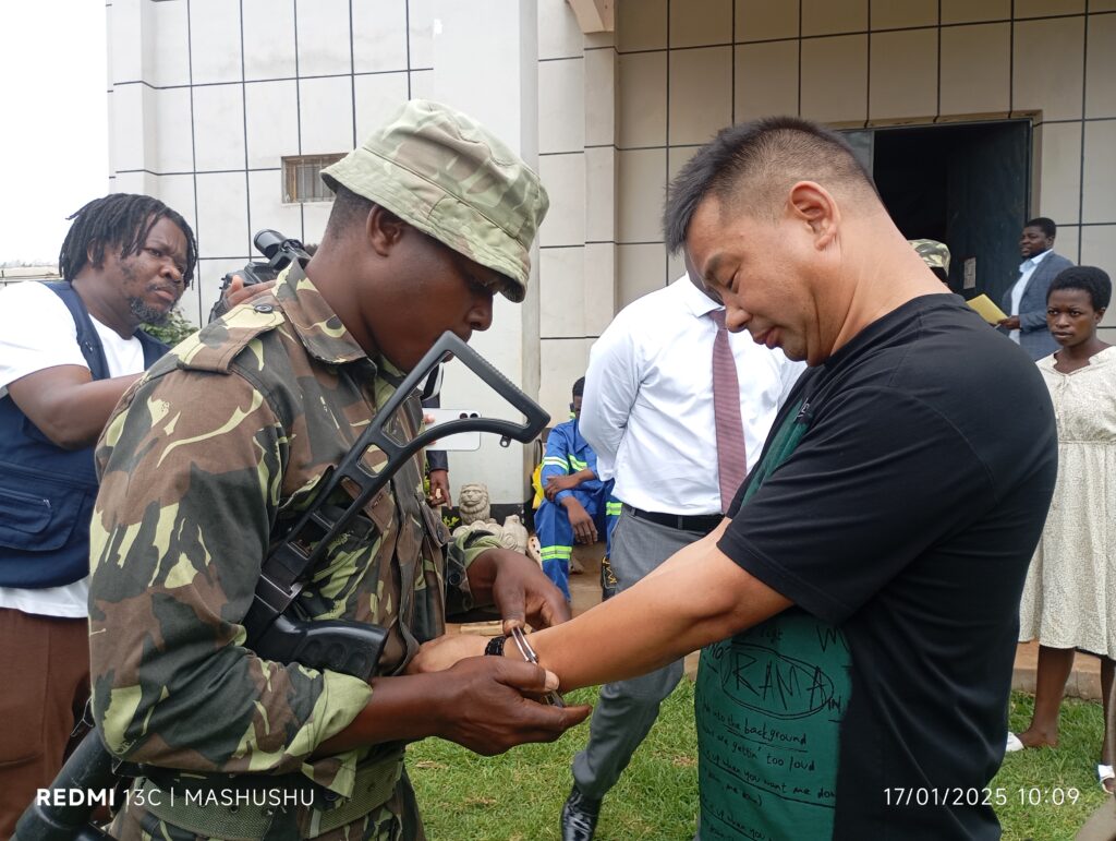Zhouh Young Fei Managing Director being arrested by the Malawi police