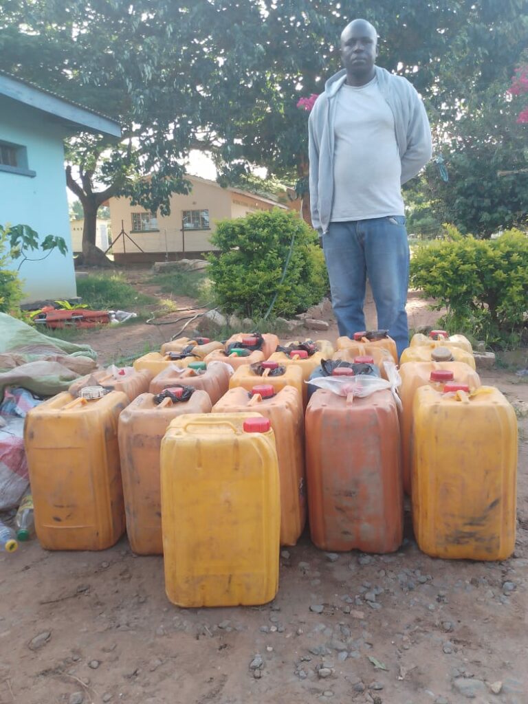Police confiscate 1,200 litres of fuel, arrest suspect in Chitipa 1 Kayola standing behind his fuel Jerry cans