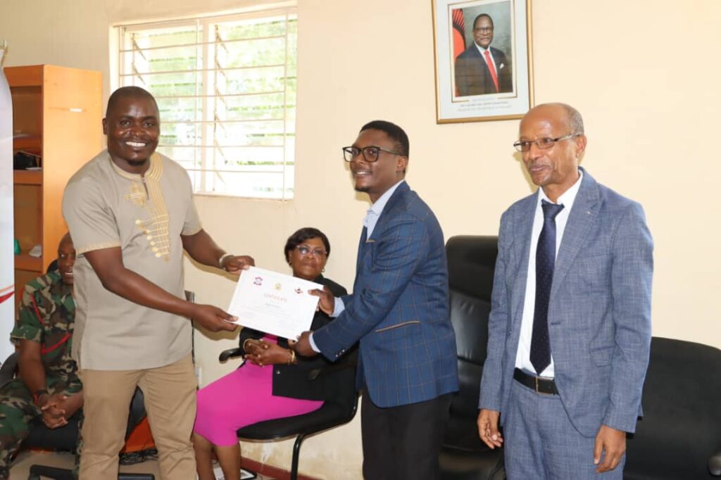 SMEDI upgrades to computer aided designing in leather shoes 1 Otaniele left presenting certificate to Dzama middle during official graduation ceremony smedi