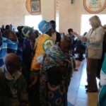 Father Sikwese joins other priests and a team from the Catholic Secretariat in presenting gifts to grandparents and the elderly persons in Dedza