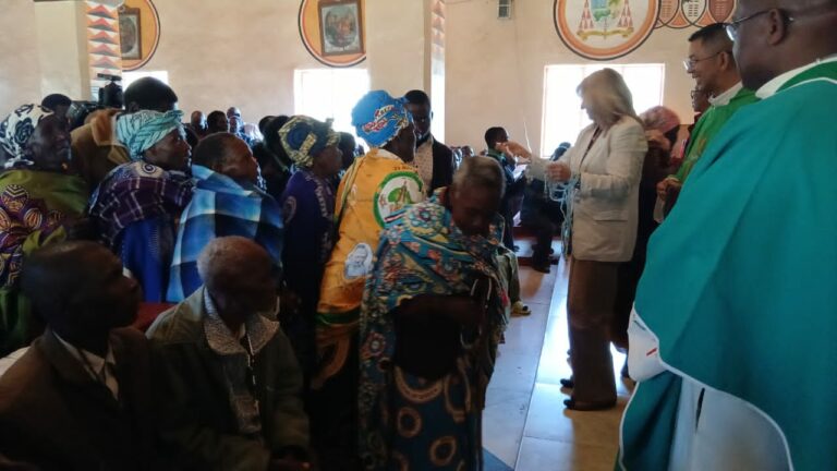 Father Sikwese joins other priests and a team from the Catholic Secretariat in presenting gifts to grandparents and the elderly persons in Dedza